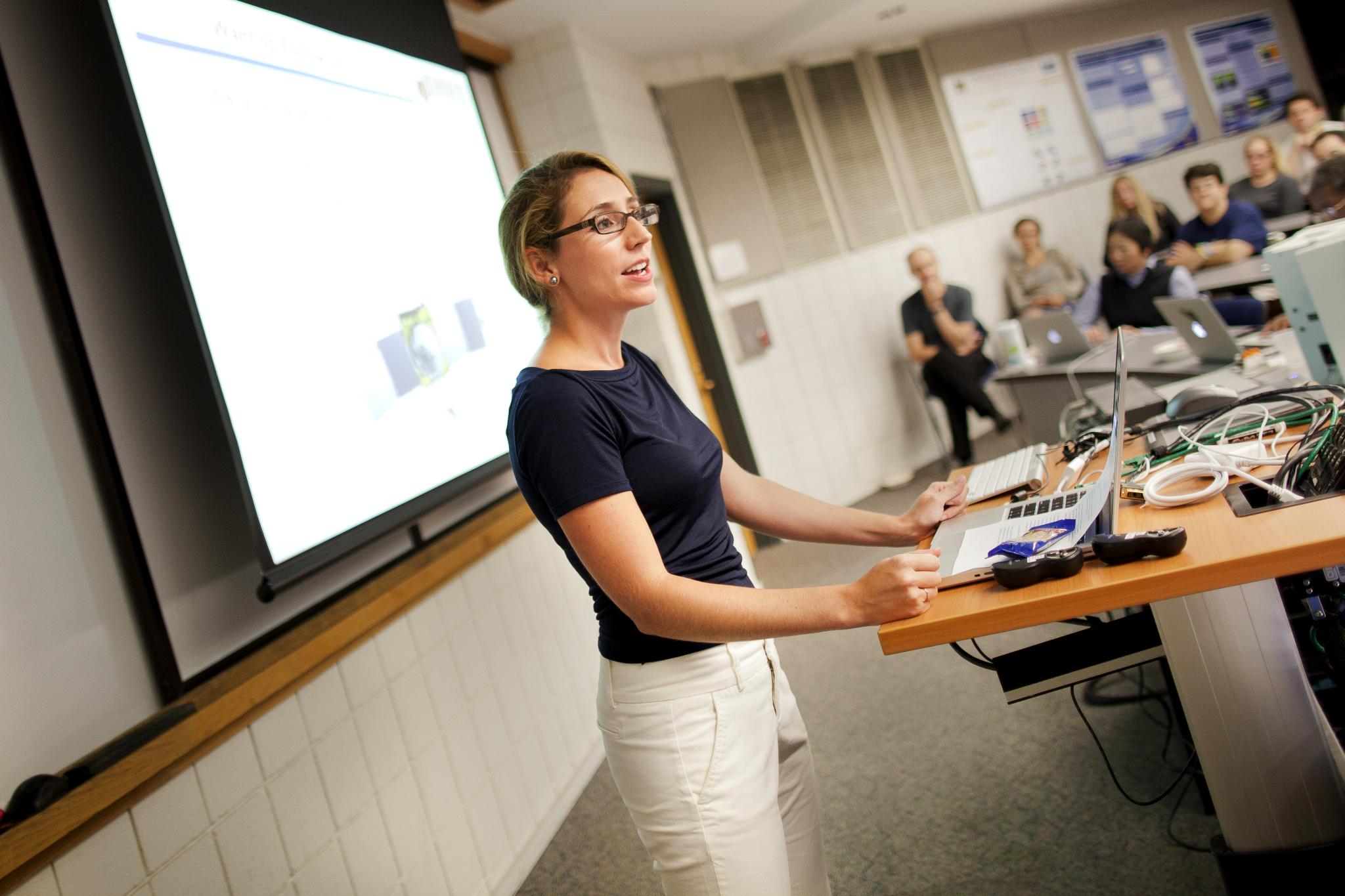 AOSS Curiosity Landing Woman stands in front of an audience in a lecture hall