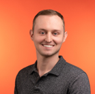 Jeremy Moghtader holding a plant next to his head