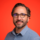 Jeremy Moghtader holding a plant next to his head