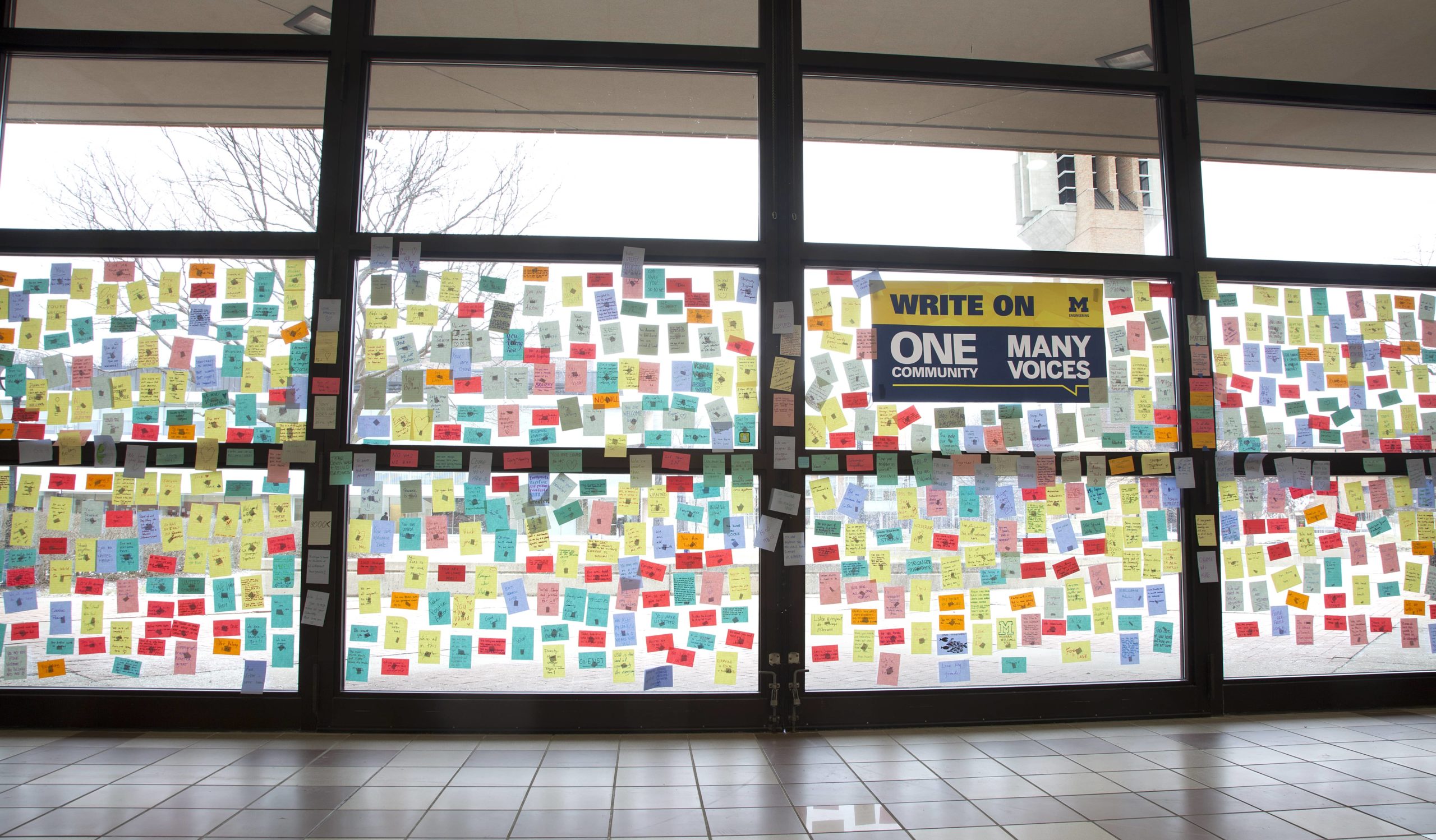 Wall covered in hand-written sticky notes as a part of an equity initiative