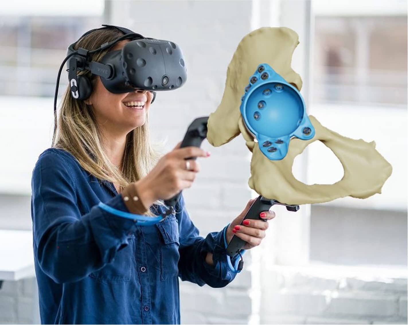 Person wearing XR goggles with displayed image of a pelvis with a highlighted blue area