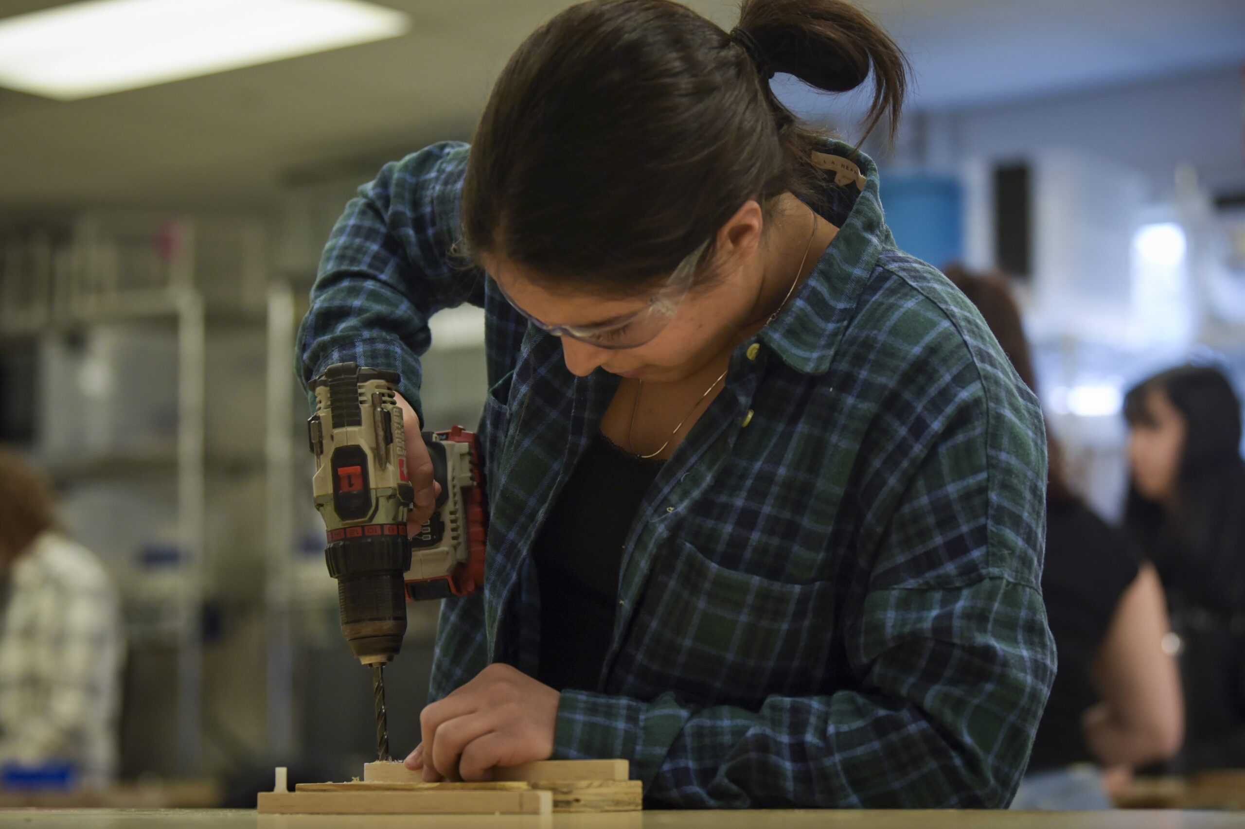 Student drilling two pieces of wood together