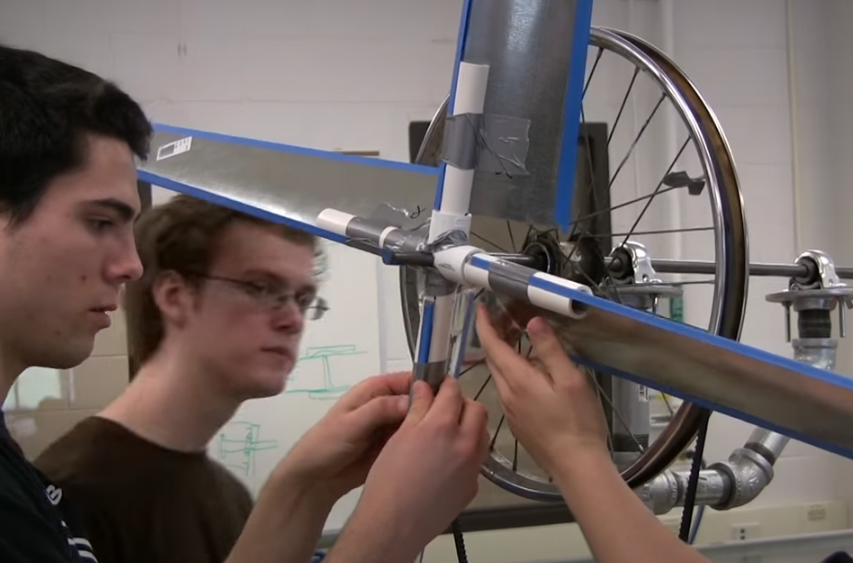 students fixing the wing with tape